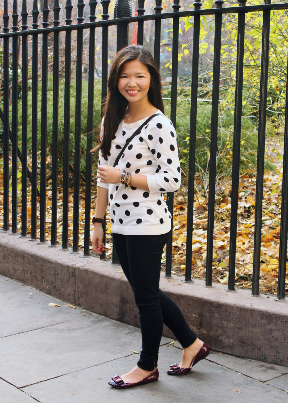 Jenny in Jacquard; NYC fashion blogger; style blog; outfit photos; Old Navy black and white polka dot sweater; Zara black skinny jeggings; Kate Spade black and white striped Scout crossbody bag; KTownsend Etsy black and gold bangles; ShoeMint Hilary bow flat in oxblood; Michael Kors tortoise gold boyfriend watch